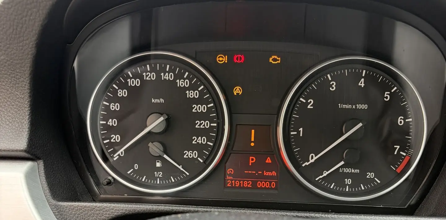 BMW instrument cluster with warning lights and frozen speed and rev display after a failed xHP flash