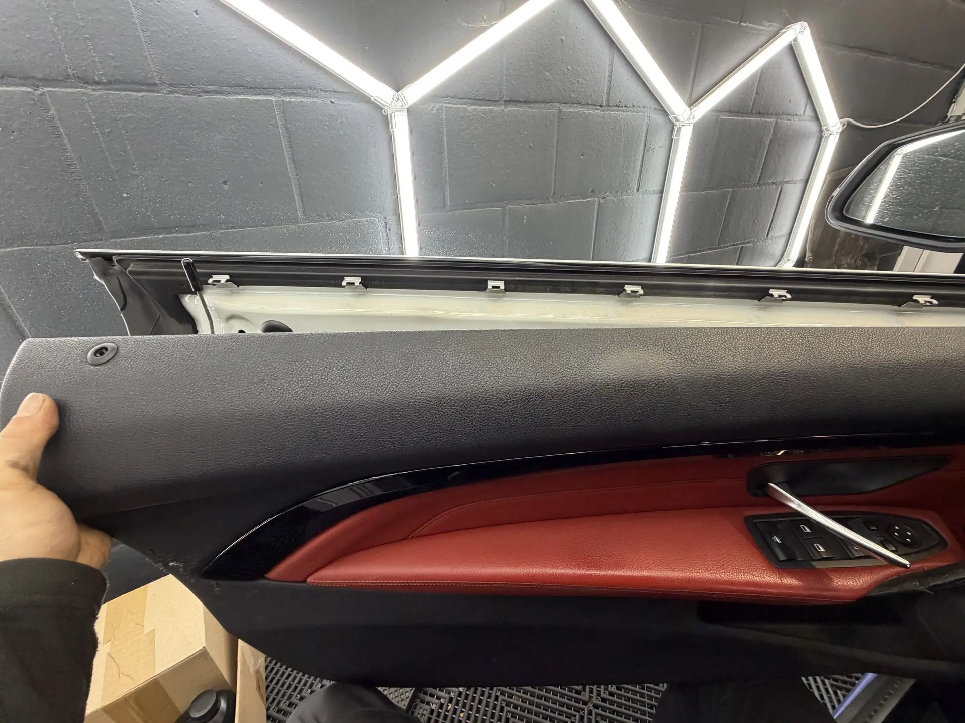 Removed BMW door panel with red leather trim