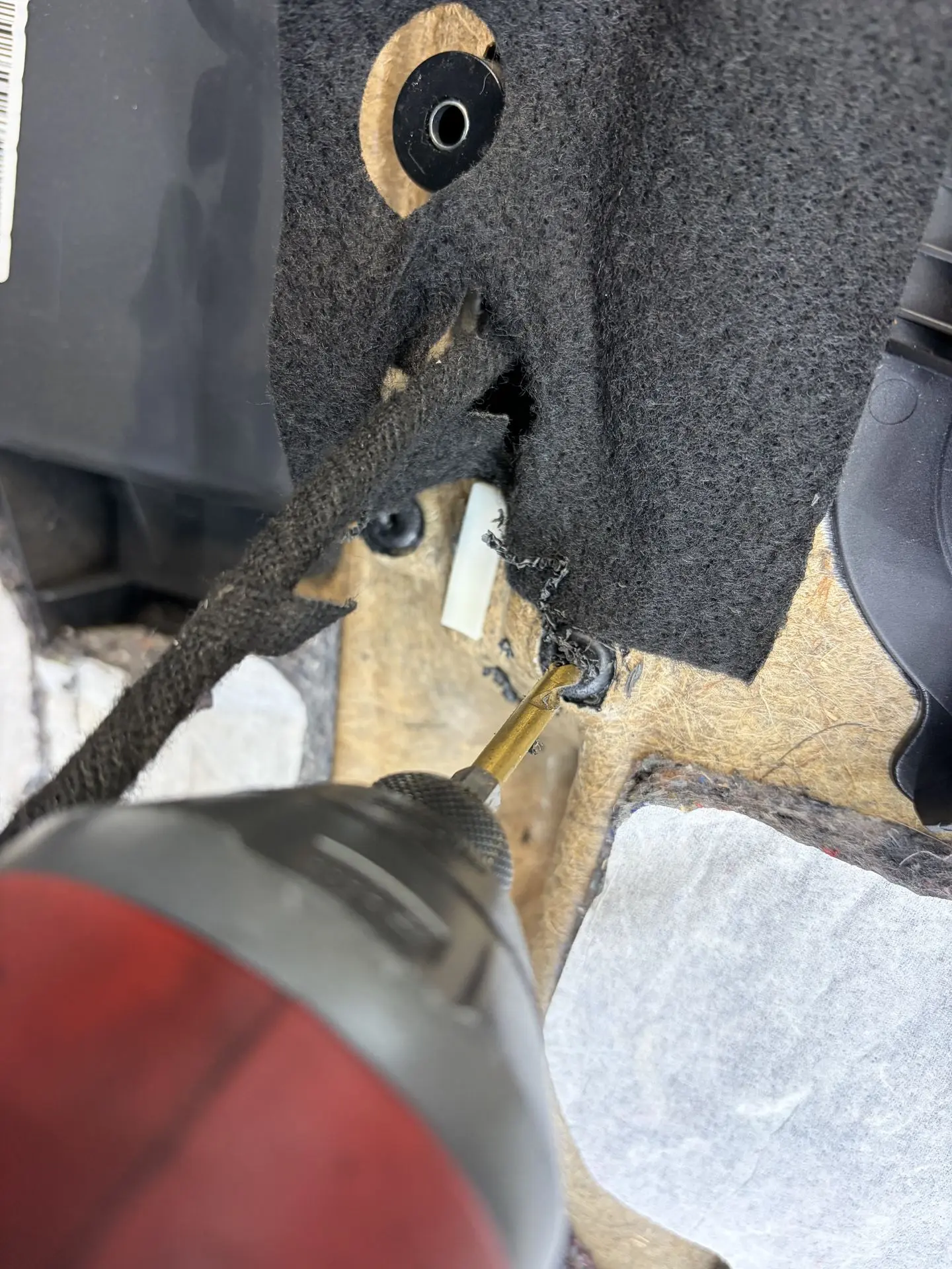 Melted plastic mounting points on the back of a BMW door panel
