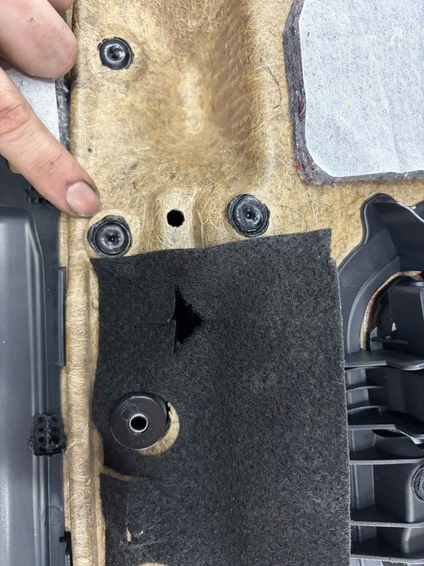 Melted plastic mounting points on the back of a BMW door panel